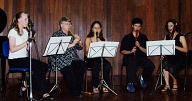 The flute ensemble, Leila playing soprano flute, Angelika next to her, then Julia, Marcos, and the teacher, Gilda.